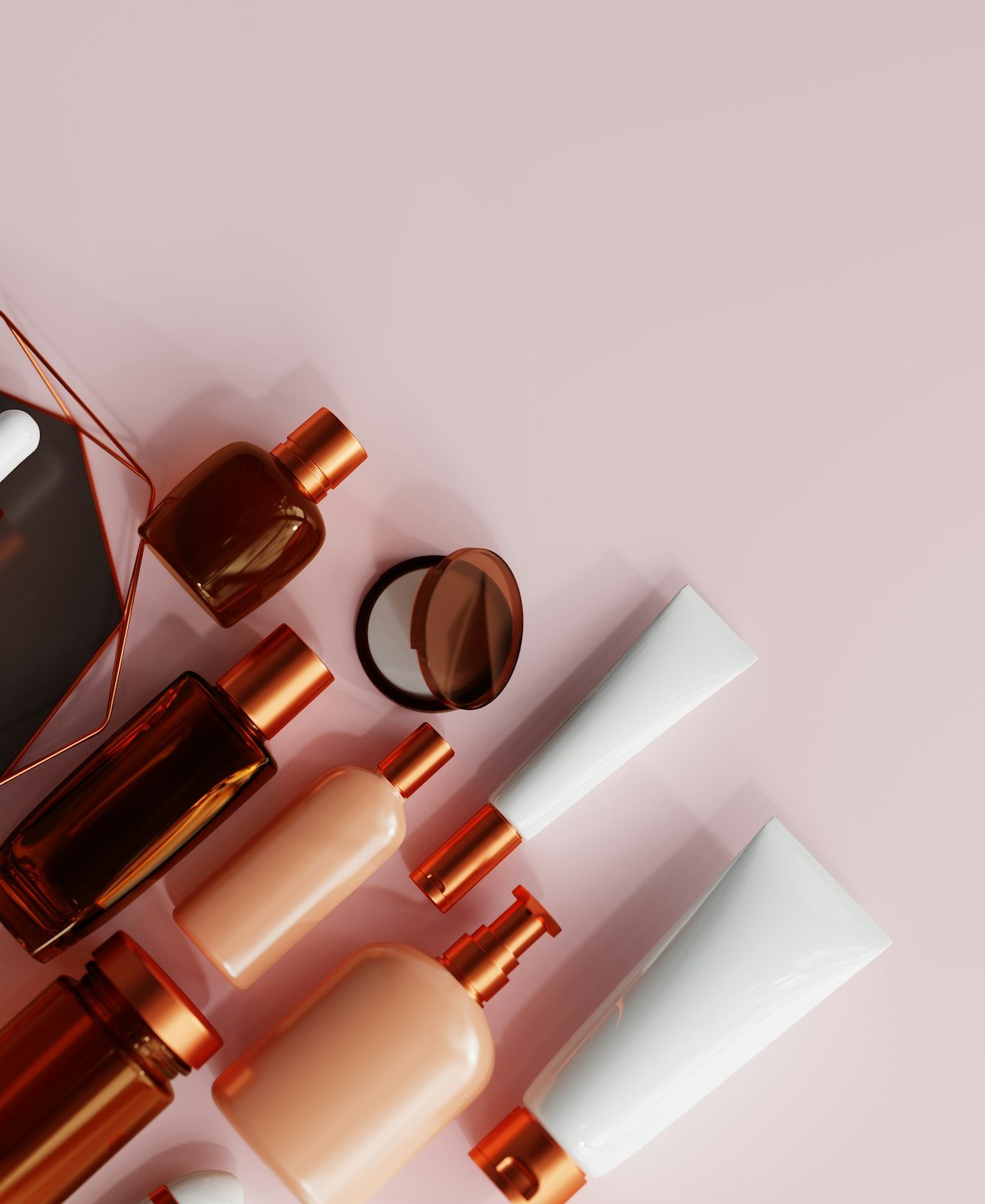 Rose-gold and blush beauty bottles arranged on a pink shelf